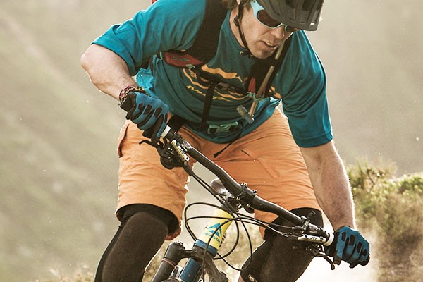 Mountain biker wearing full finger gloves with knuckle protection